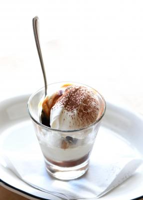 Ice cream dessert in a glass with a spoon